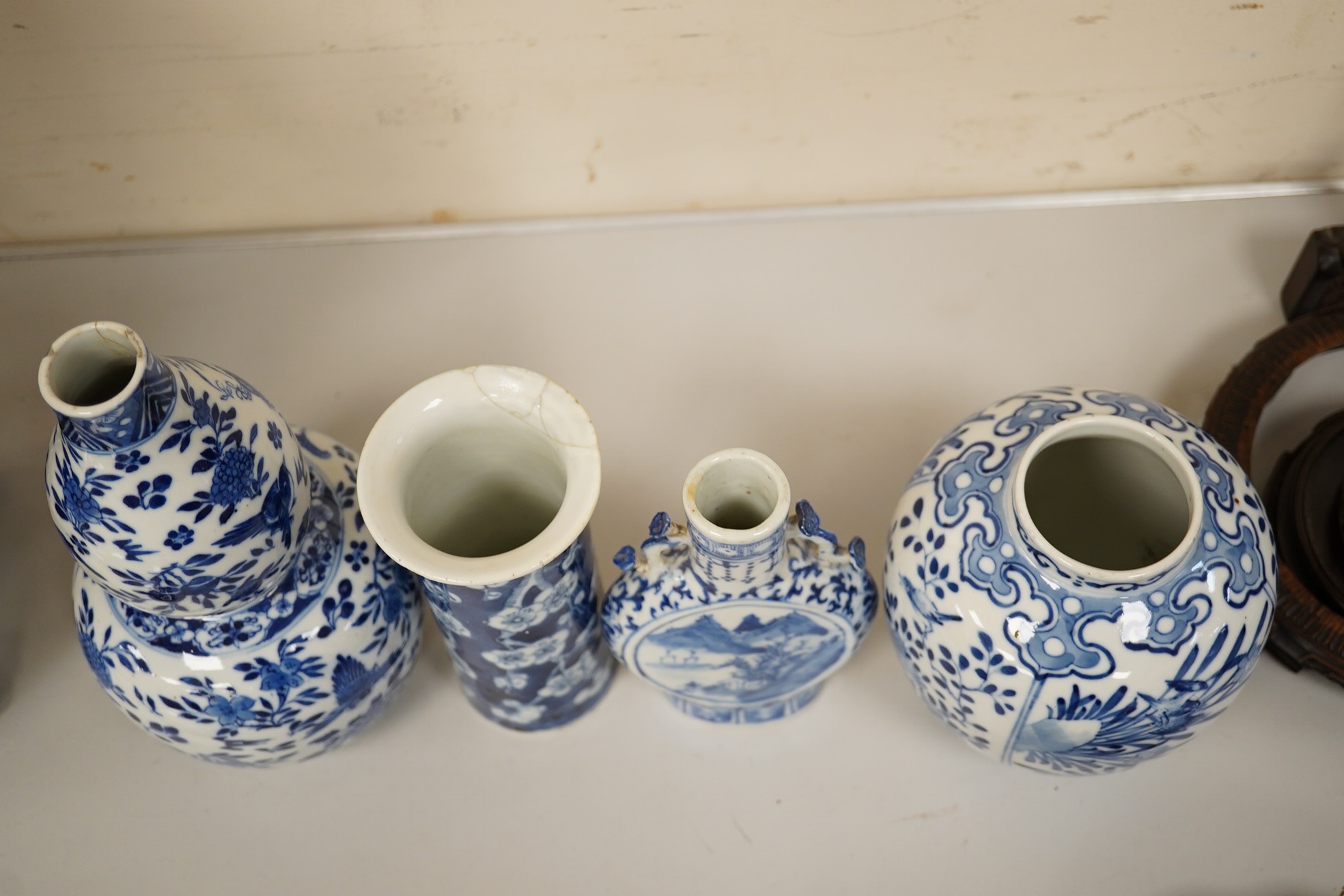 Four 19th century Chinese blue and white jars / vases, including a moon flask and double gourd vase, largest 23cm high. Condition - poor